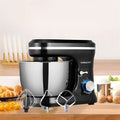 Black stand mixer with stainless steel bowl and three attachments including cream blender and egg beater
