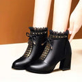 Black studded chunky heel martin boots in black leather ankle design with gold heart studs and lace trim