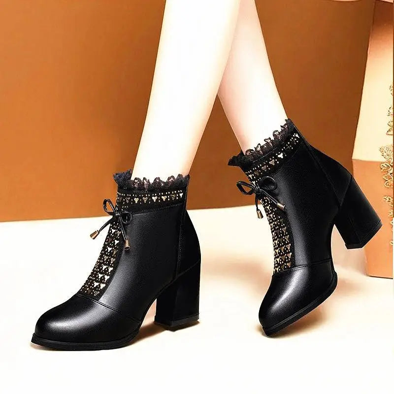 Black leather ankle boots with lace-up detailing and a black studded chunky heel martin design