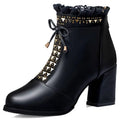 Black leather ankle boot with chunky heel martin design featuring gold heart cutouts and rhinestones on cuff and side