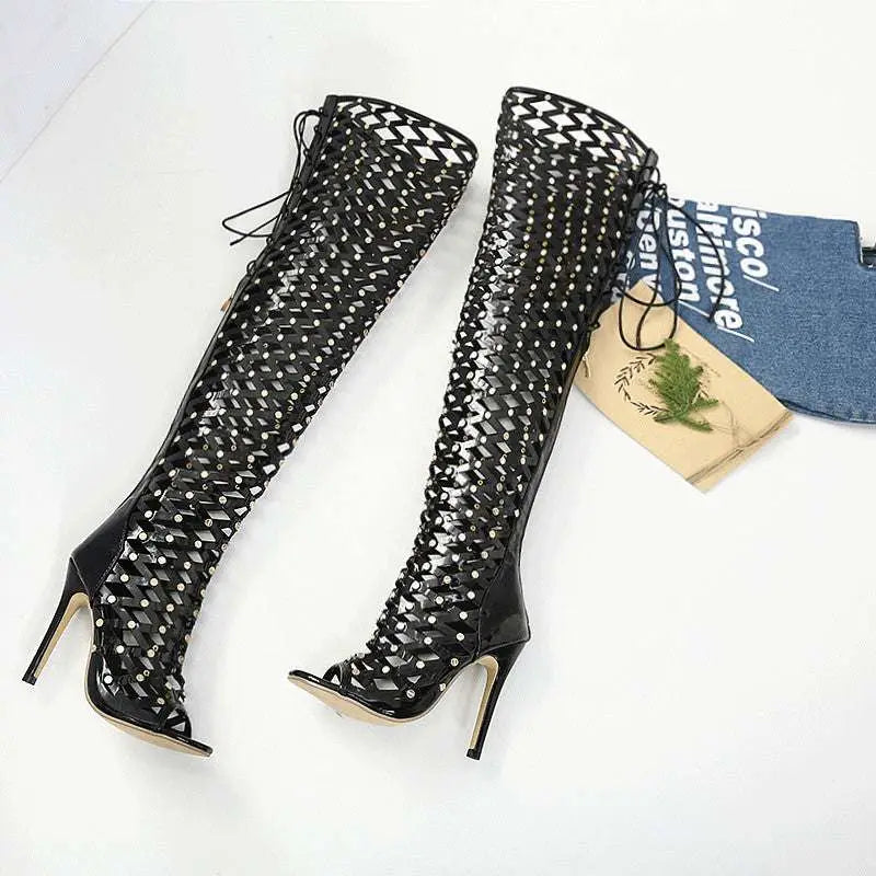 Black studded lace heel sandal boots featuring over-the-knee design with high stiletto heel and silver studs