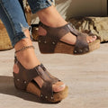 Brown zipper wedges sandals with lightweight height increasing cork soles and silver studs on leather upper