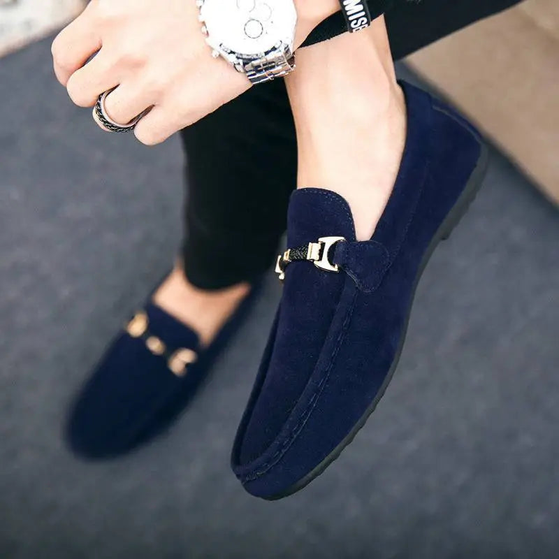 Navy blue suede loafers with gold-tone horsebit buckle and flat heel ideal for casual wear