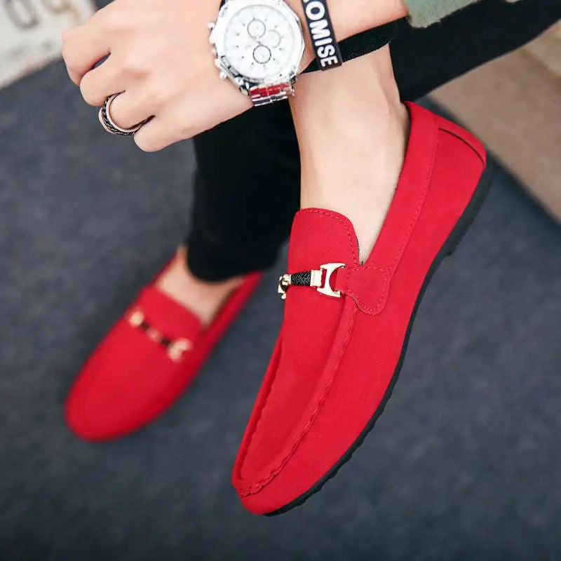 Red suede loafers with a metallic gold-tone horsebit buckle and flat heel for casual wear