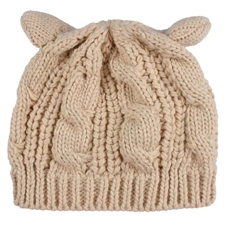 Beige knitted cat ear beanie with cable knit pattern and soft rounded ear-like protrusions in cozy style