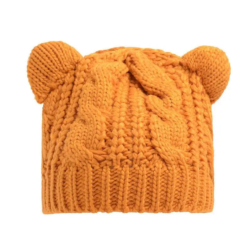 A cozy orange knitted beanie with cable knit pattern and rounded bear ears, contrasting black textured cute cat ear beanie style