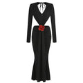 Black v-neck backless long sleeves mermaid skirt waist gown with deep v-neck and red fabric rose accent at waist seen from back