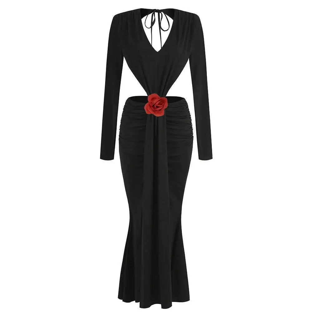 Black v-neck backless long sleeves mermaid skirt waist gown with deep v-neck and red fabric rose accent at waist seen from back