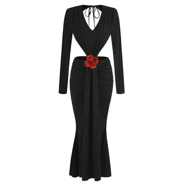 Black v-neck backless long sleeves mermaid skirt waist gown with deep v-neck and red fabric rose accent at waist seen from back
