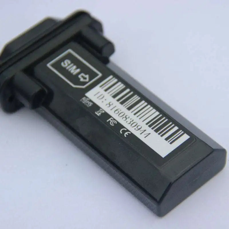 Black vehicle tracking gps locator showing black plastic tracker back with barcode sim card slot and regulatory markings for vehicle tracking applications