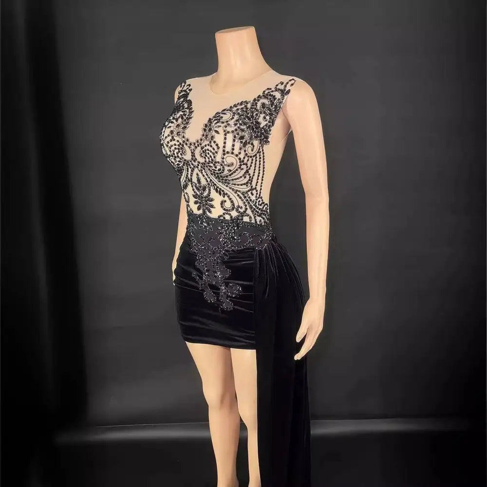 Black velvet luxury evening dress with intricate lace detailing on the bodice and a high slit with side train
