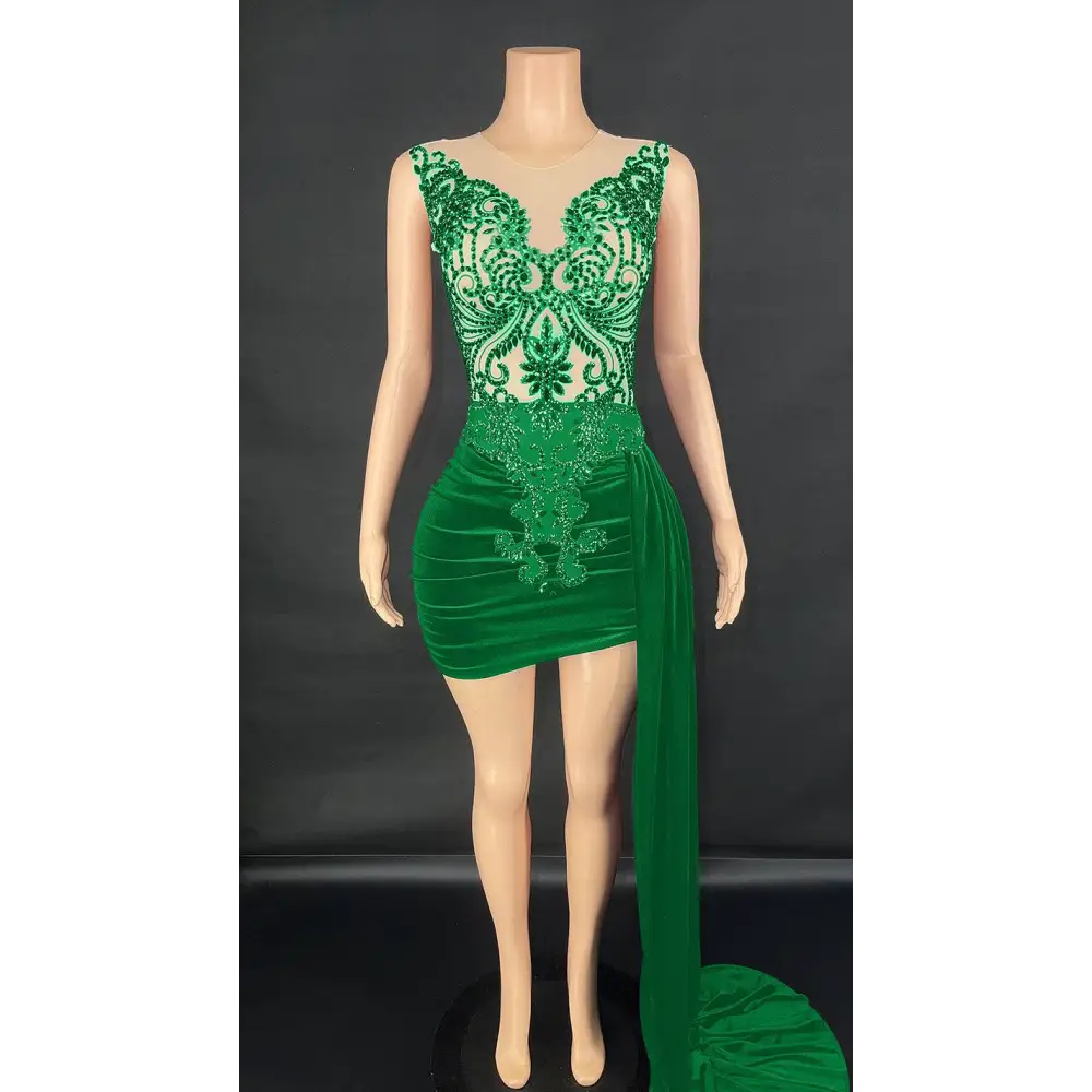 Emerald green velvet luxury evening dress with intricate lace detailing and a side slit for elegant occasions