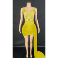 A luxury evening dress featuring vibrant yellow sequins, a sheer bodice, and a velvet luxury evening side train