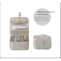 Beige oxford khaki fabric makeup and toiletries bag with clear mesh pockets and hanging hook for black wall mounted portable women use