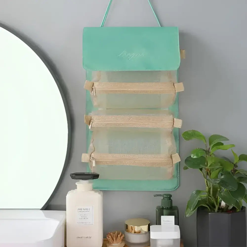Mint green fabric wall mounted portable women makeup bag with three transparent mesh compartments and wooden accents