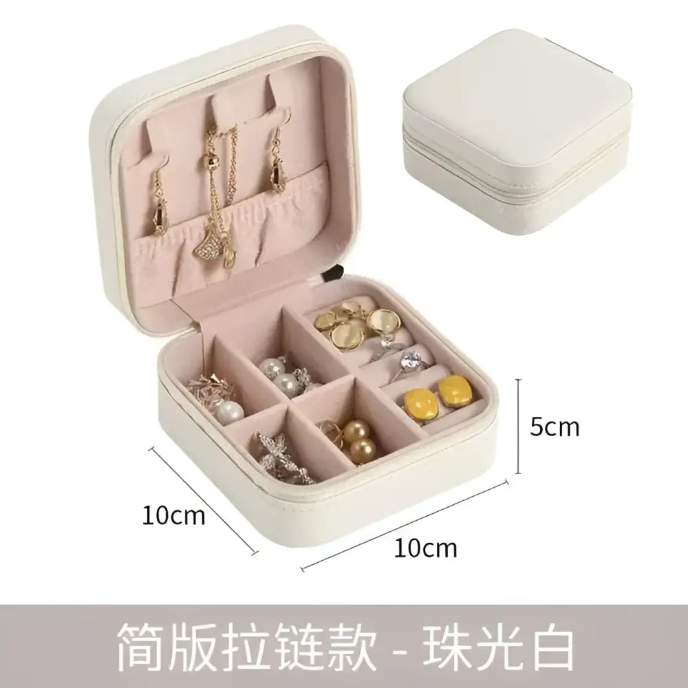 A compact cream-colored faux leather jewelry box with soft pink lining and compartments, ideal for black wall mounted portable women makeup storage