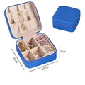 Blue faux leather jewelry box with beige interior compartments and zipper closure for portable women makeup storage