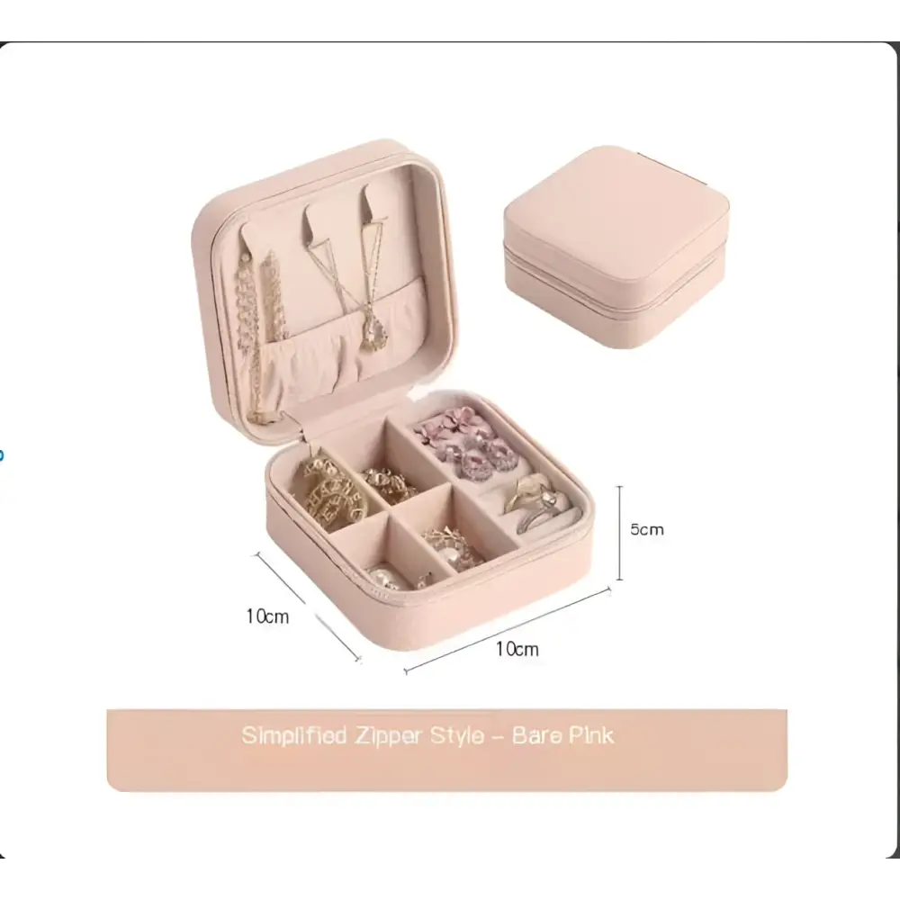 A blush pink compact jewelry box with zipper closure and compartments for a black wall mounted portable women makeup bag