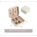 Pearl white zipper-top jewelry box with soft compartments and padded earring holders in black wall mounted portable women makeup bag