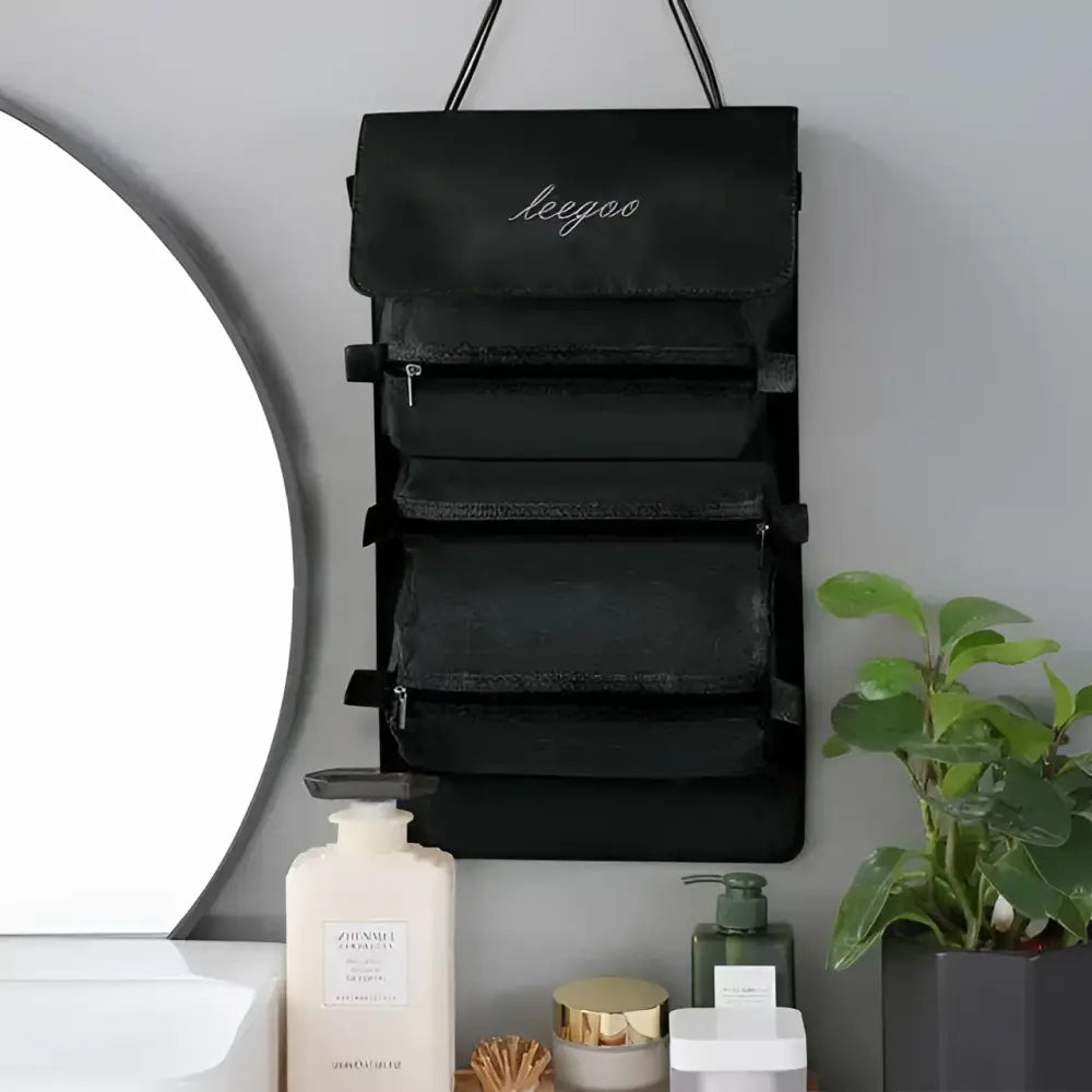 Black wall mounted portable women makeup bag with five zippered compartments and embroidered brand name