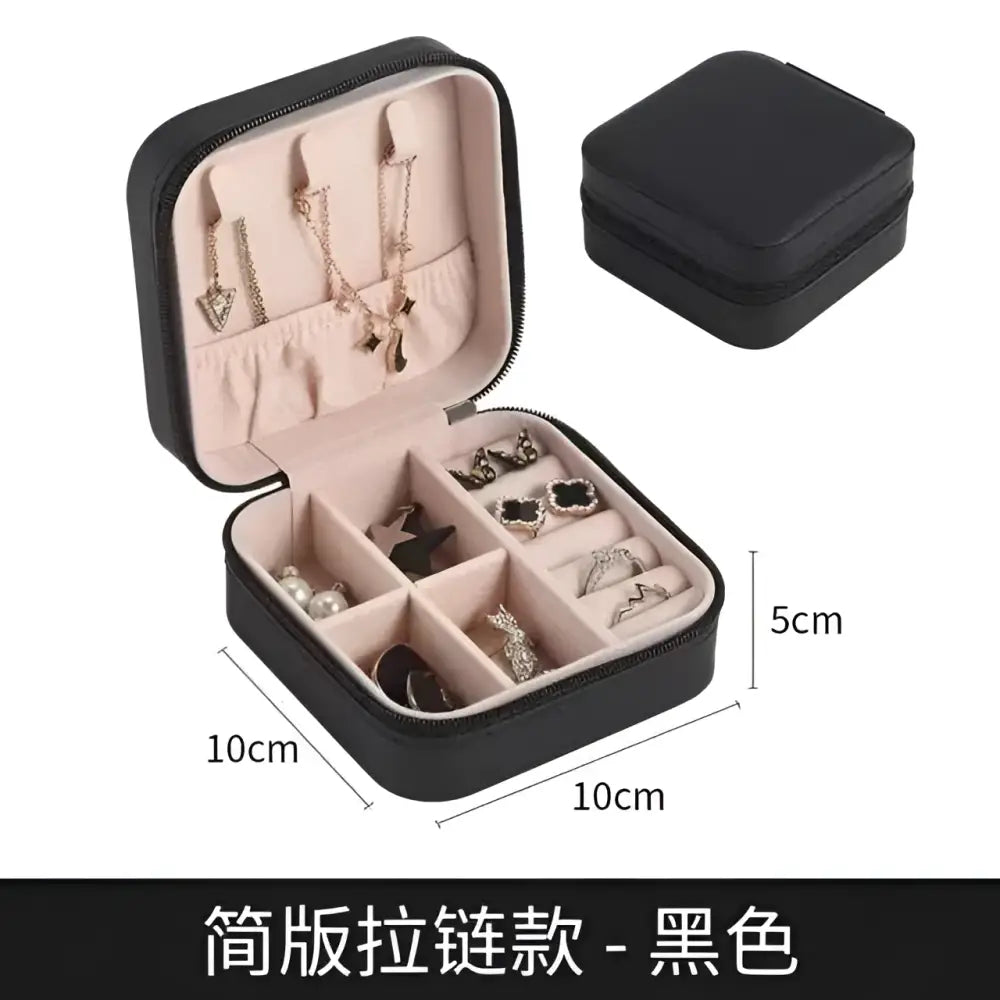 Black wall mounted portable women makeup bag in black leatherette with pink interior compartments and zipper closure