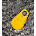 Bright yellow plastic key fob with button and hole for black water drop anti lost object lost object finder