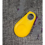 Bright yellow plastic key fob with button and hole for black water drop anti lost object lost object finder