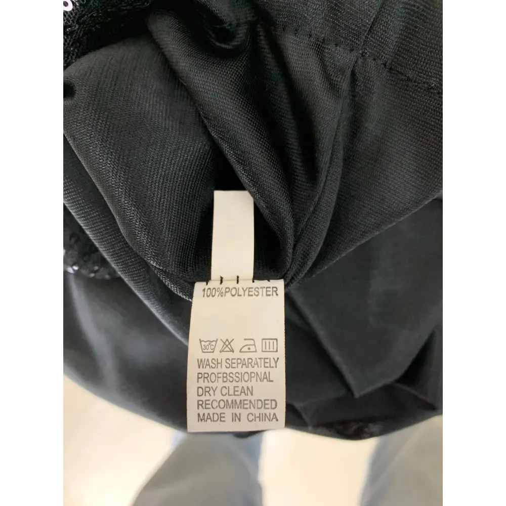 Black polyester garment care label with white text and symbols for winter sexy backless sequined mermaid gown