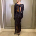 Black winter sexy backless sequined mermaid gown with back bow and high slit shown from the back side