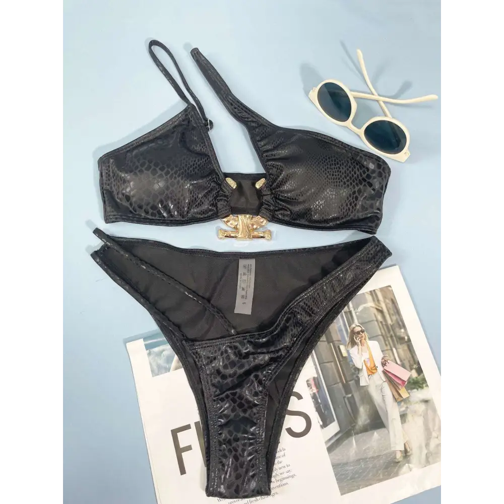 Black women bikini serpentine pattern set with snakeskin texture and gold-toned bone-shaped clasp detail