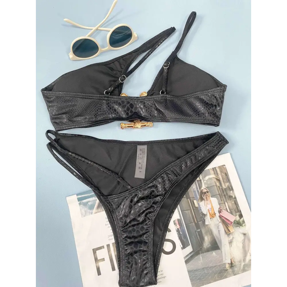 Black women bikini serpentine pattern set with snakeskin texture and gold-toned bone-shaped clasp hardware