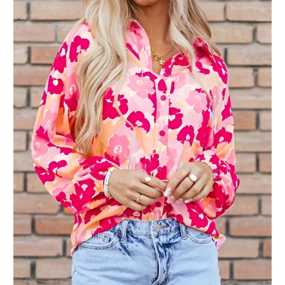 A vibrant pink and orange blooming floral print puff sleeve shirt with long sleeves and a lightweight fabric design