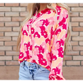 A blooming floral print puff sleeve shirt in vibrant pink and peach with a button-down front design