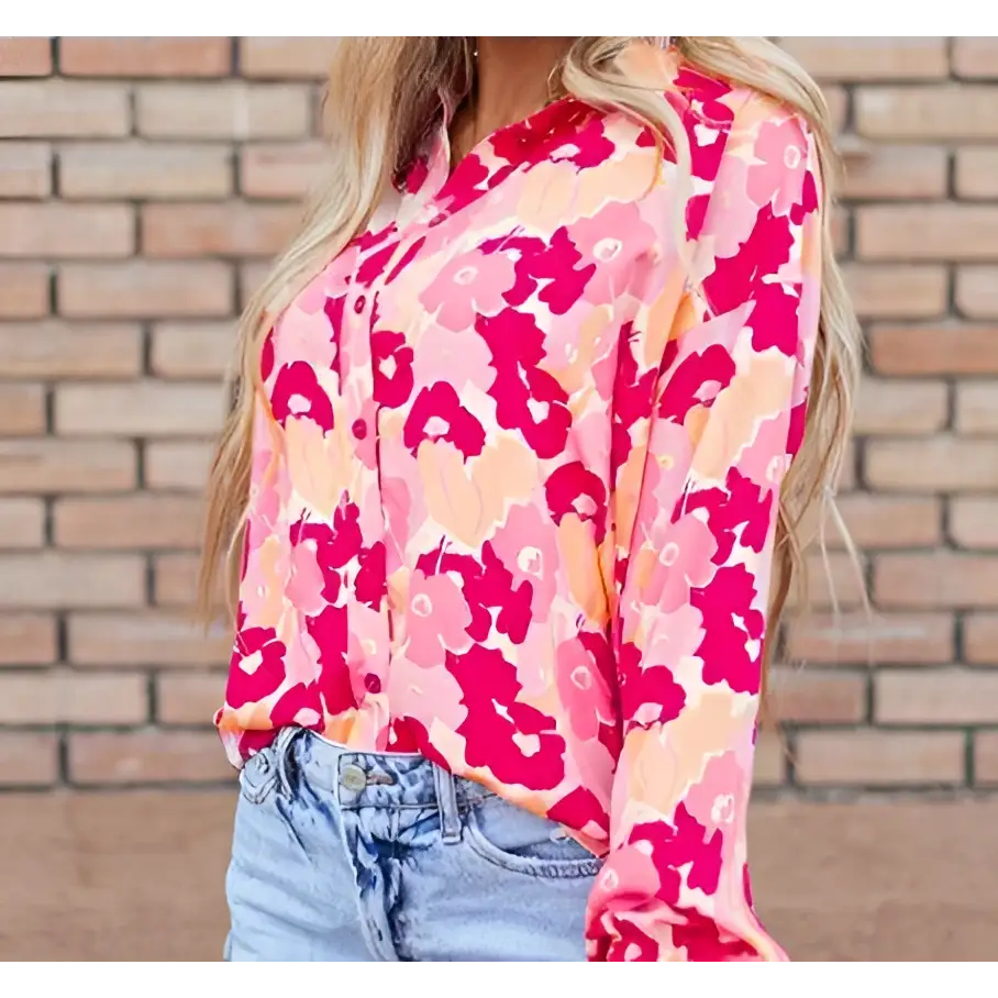 A blooming floral print puff sleeve shirt in vibrant pink and peach with a button-down front design