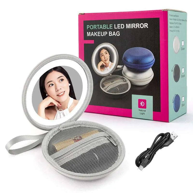 Silver circular led round bag mirror with mesh-lined blue carrying case and usb charging cable for travel use