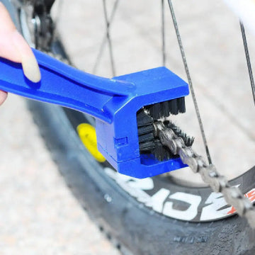Blue plastic bicycle chain cleaner with large black bristle from bicycle cleaning tool set for effective maintenance