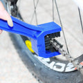 Blue plastic bicycle cleaning tool set with large bristle and serrated edge featuring black plastic body and blue logo