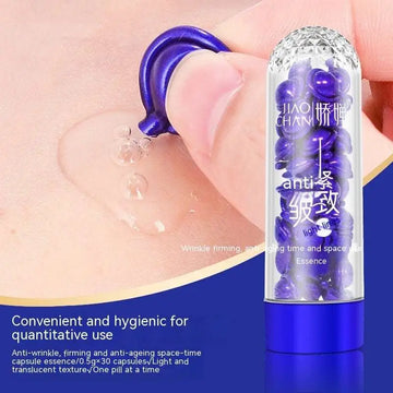 A clear glass tube with blue metallic cap filled with purple anti-wrinkle jiao chan aging essence capsules blue big chicken