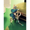 Blue butterfly mori style shark clip with gold tone, embroidered teal wings, beads, pearls, and teardrop charms