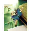 Blue butterfly mori style shark clip with delicate beads pearl accents and gold-toned metal clasp device shark clip