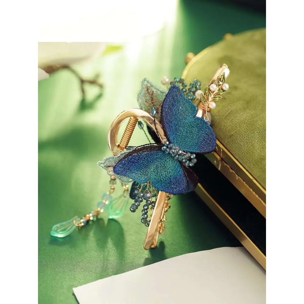 Blue butterfly mori style shark clip with delicate beads pearl accents and gold-toned metal clasp device shark clip