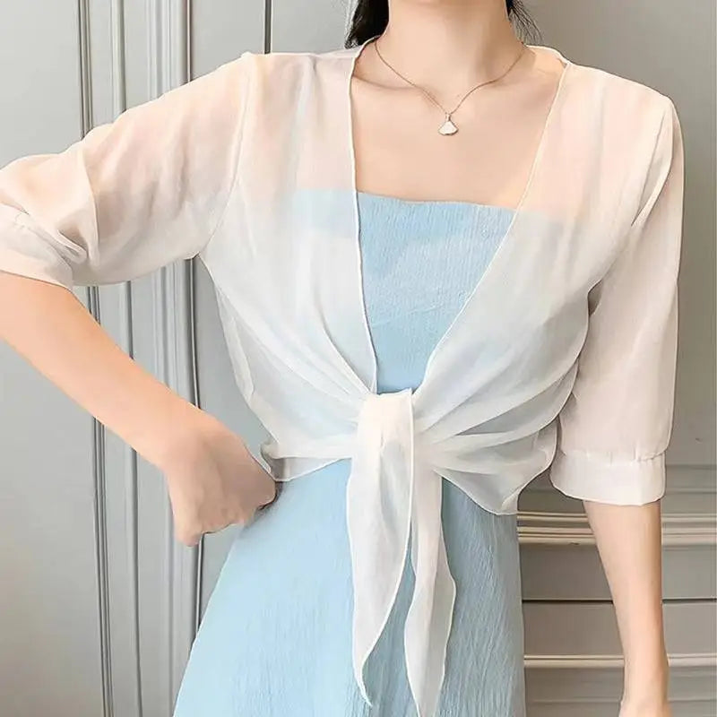 A sheer pale pink chiffon short shawl with three-quarter sleeves and a tied front knot for summer wear