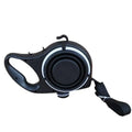 Black retractable dog leash with ergonomic handle and white accent rings paired with blue collapsible pet water bottle with pet rope