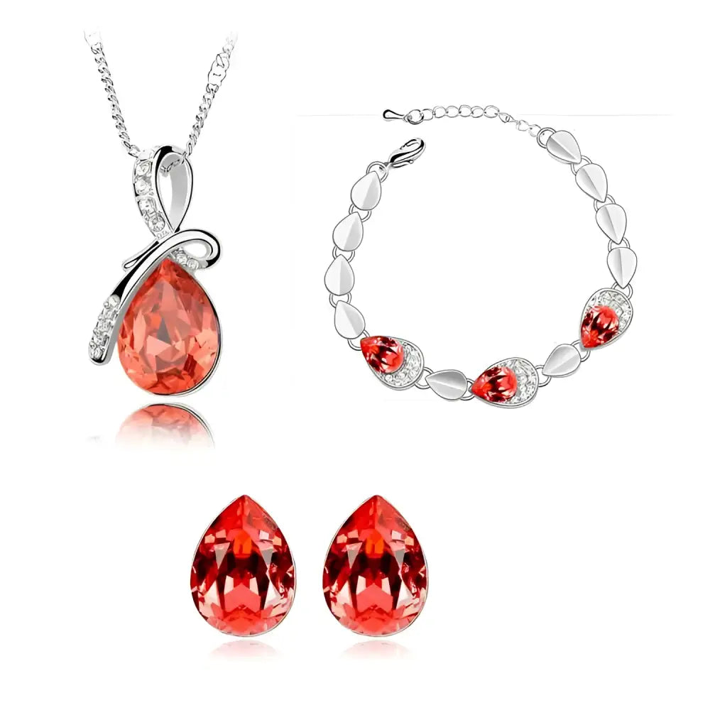 A blue crystal alloy jewelry set featuring red teardrop crystals with silver-toned creative alloy necklace bracelet and earrings