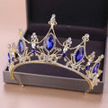 A golden headband adorned with deep blue and clear crystals in an elegant blue crystal crown bride design