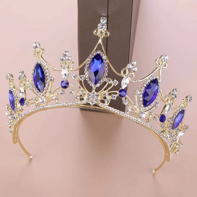 A golden headband adorned with deep blue and clear crystals for a crystal crown bride and blue crystal crown look