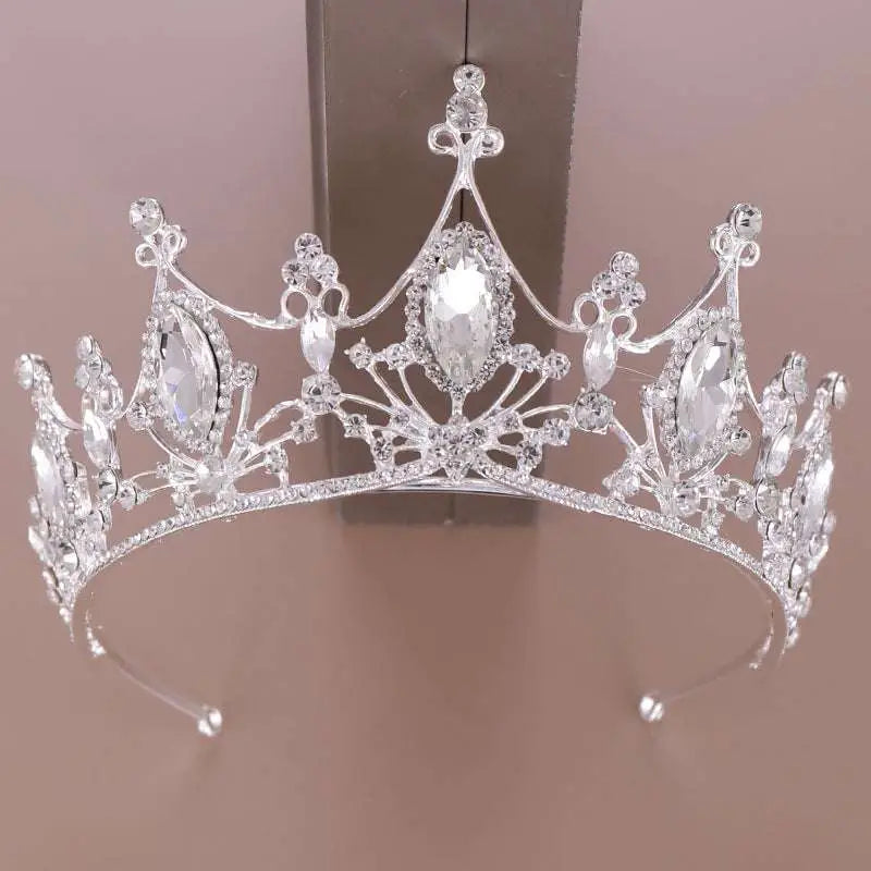 A sparkling silver crystal crown bride with clear crystals and intricate filigree as a golden headband adorned