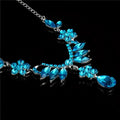 A sparkling blue crystal explosion bride alloy necklace with silver chain and intricate floral and leaf designs