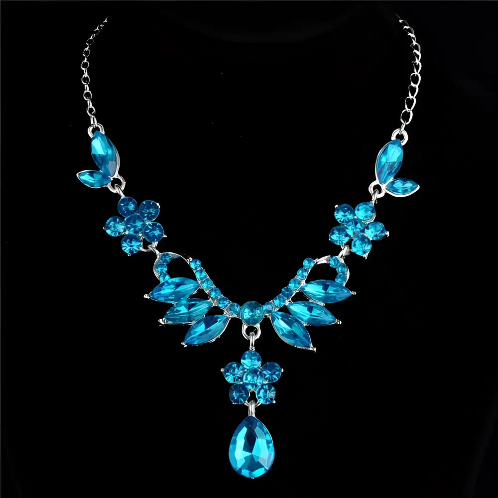 A sparkling blue crystal explosion bride alloy necklace with floral leaf motifs and a central teardrop pendant