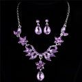 Purple crystal floral necklace with matching earrings featuring silver alloy metalwork in blue crystal explosion bride set
